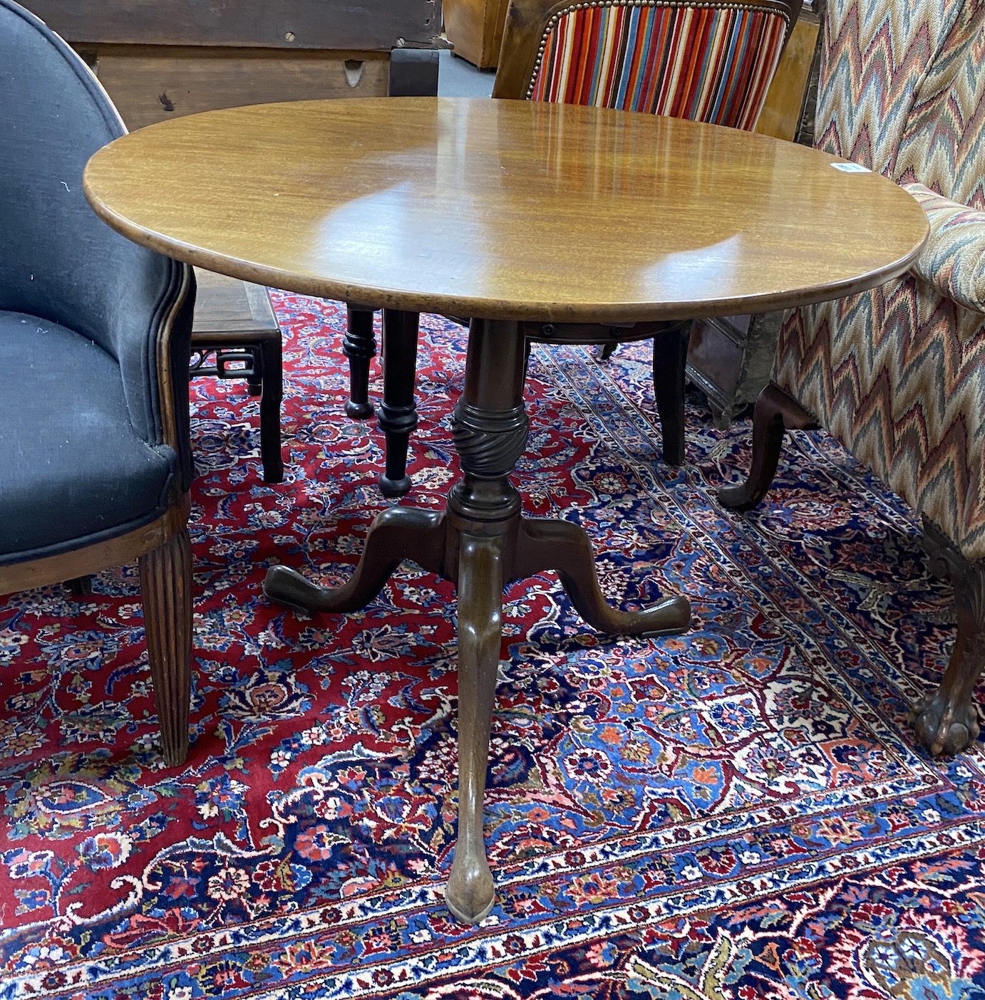 A George III mahogany circular tilt top tripod tea table, diameter 89cm, height 74cm
